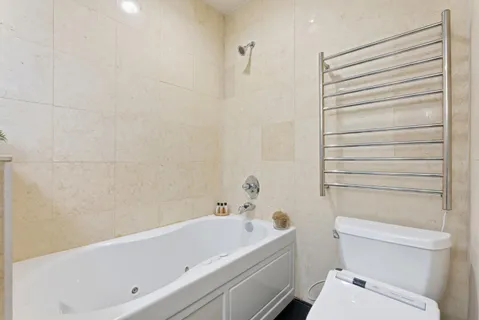 a living room with furniture or chandelier and a wooden floor