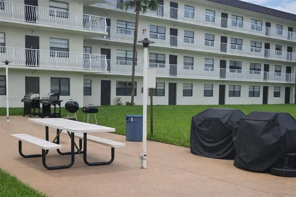 a view of a patio with couches table and chairs and potted plants