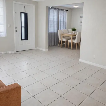 a view of a room with furniture and window