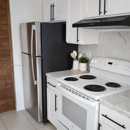 a kitchen with a stove and refrigerator