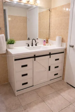 a bathroom with a sink vanity and mirror