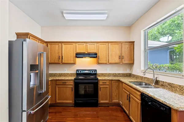 a kitchen with a sink stove and refrigerator