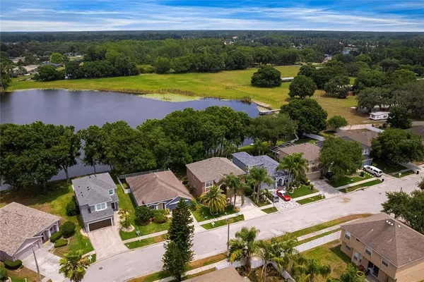an aerial view of residential houses with outdoor space and swimming pool