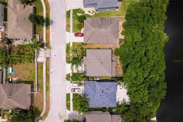 an aerial view of a house with a yard