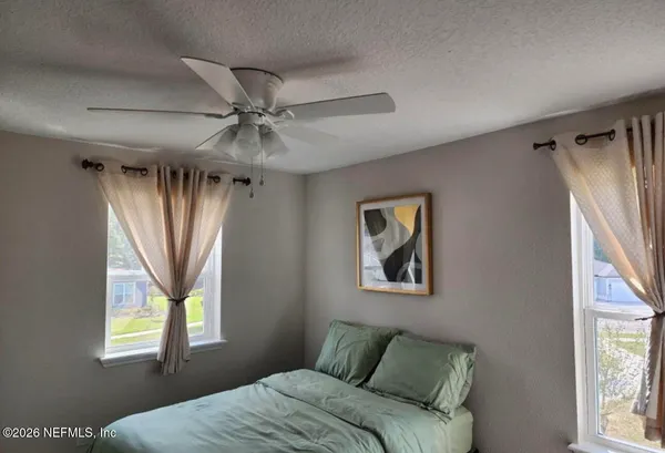 a bedroom with a bed and a window