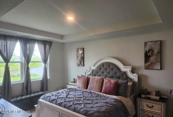 a bedroom with a large bed and a window