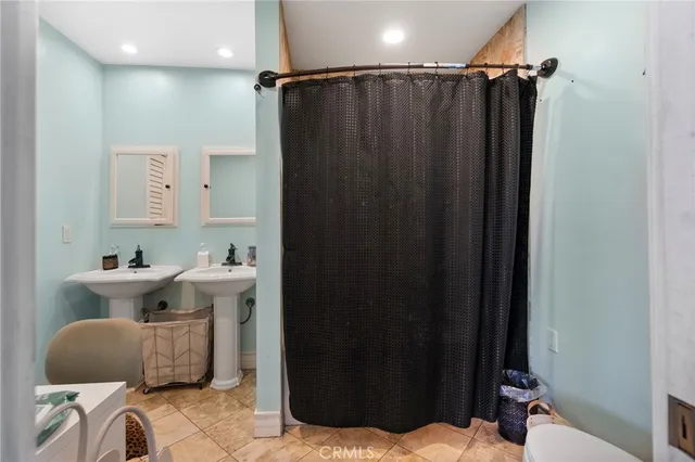 a bathroom with a sink a toilet and mirror