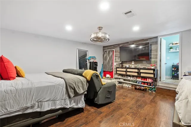 a view of a patio with table and chairs under an umbrella with a small yard