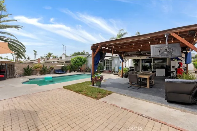 a view of a house with garden and sitting area