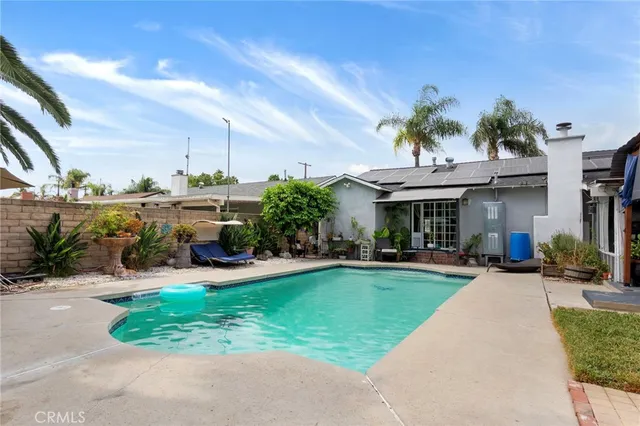 a view of a house with sitting area and a yard