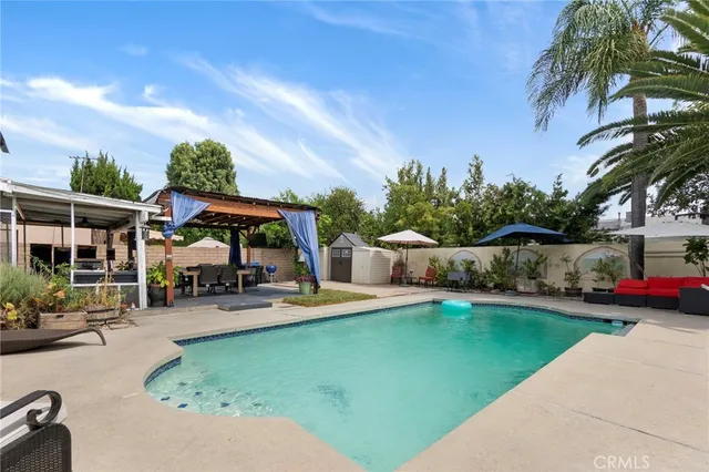 a swimming pool with outdoor seating and yard