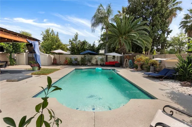 a view of a backyard with swimming pool