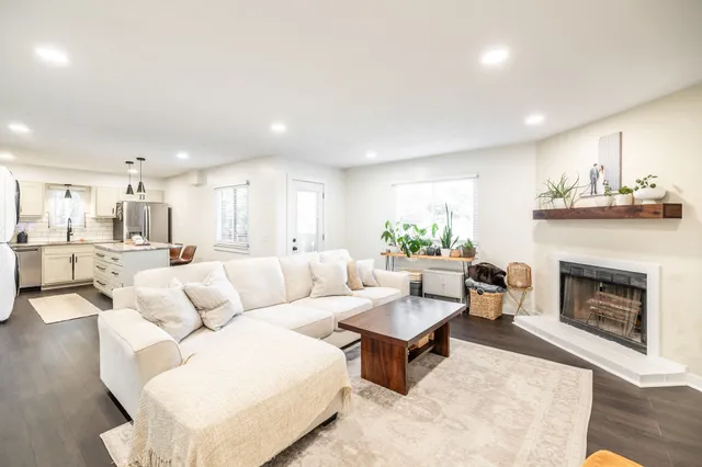 a living room with furniture and a fireplace