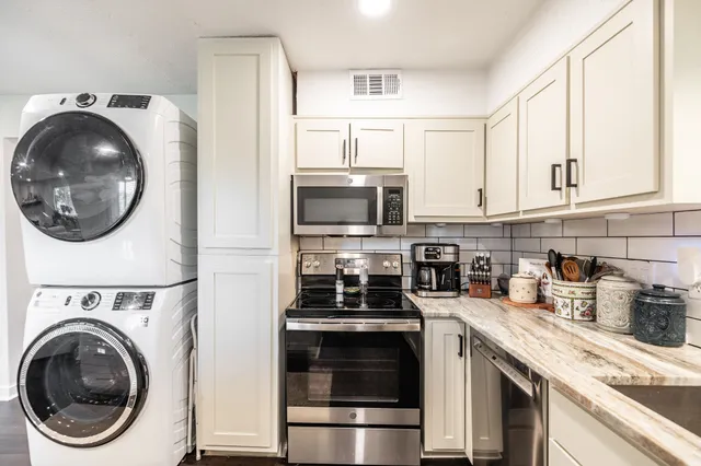 a kitchen with a stove a washer and dryer