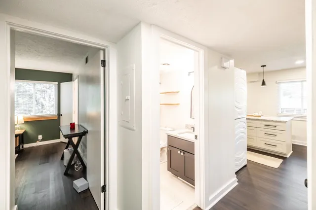 a view of a hallway with furniture and a window