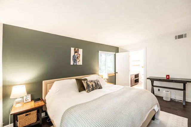 a bedroom with a bed and a lamp