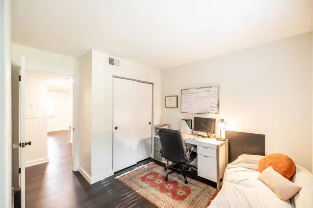 a view of a workspace with furniture and wooden floor
