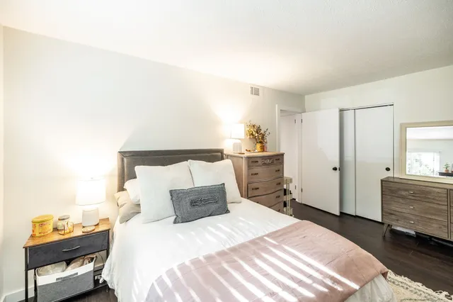 a bedroom with a bed and a dresser