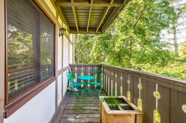 a view of a two chairs in the balcony