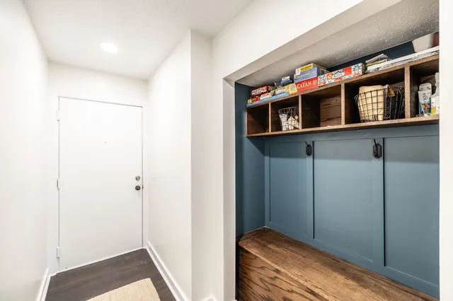 a bedroom with closet and wooden floor