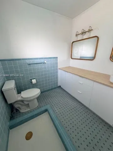a bathroom with a sink a toilet and mirror