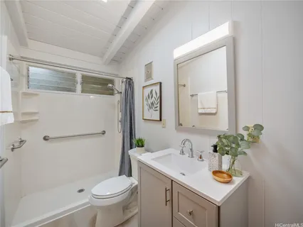 a bedroom with a bed and a potted plant