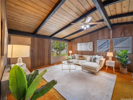 a outdoor living space with furniture potted plant and a large window