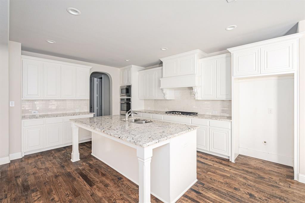 1506 Mariners Hope Way Wylie, TX 75098 - Photo 12 of 28 a kitchen with a sink stove and refrigerator