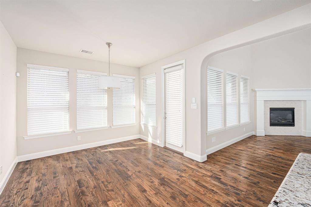 1506 Mariners Hope Way Wylie, TX 75098 - Photo 13 of 28 a view of an empty room with window and wooden floor