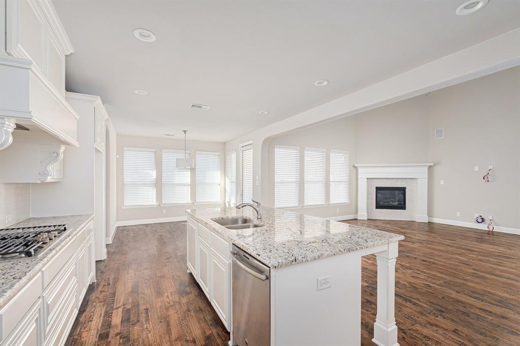 1506 Mariners Hope Way Wylie, TX 75098 - Photo 14 of 28 a open kitchen with granite countertop a stove and a sink
