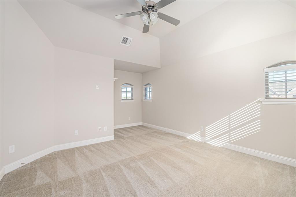 1506 Mariners Hope Way Wylie, TX 75098 - Photo 24 of 28 an empty room with a ceiling fan and windows