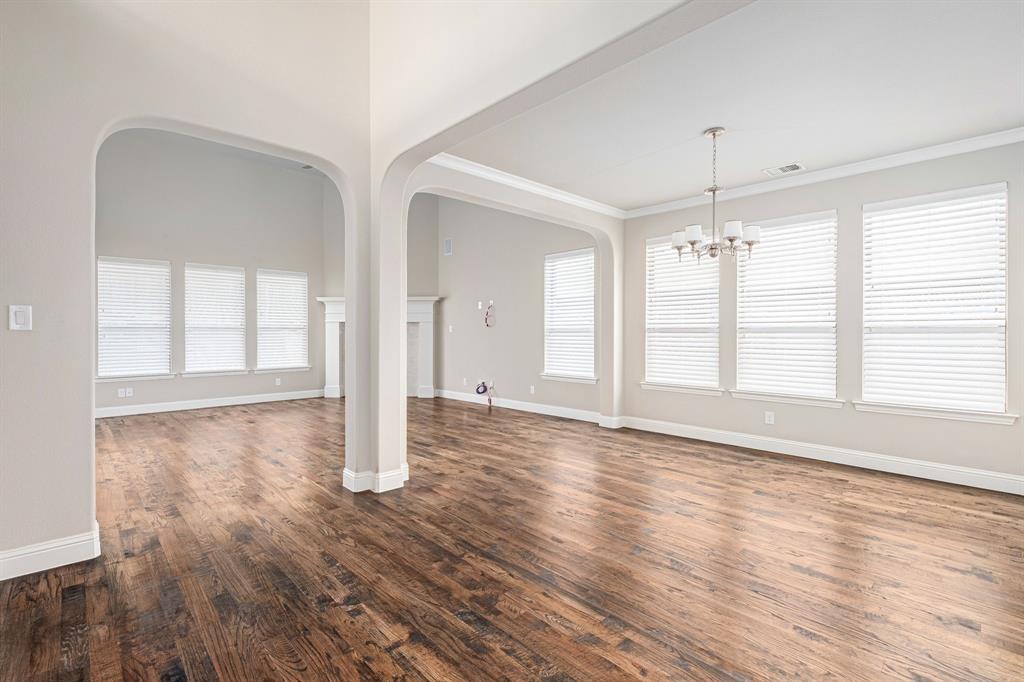 1506 Mariners Hope Way Wylie, TX 75098 - Photo 7 of 28 a view of an empty room with wooden floor and a window