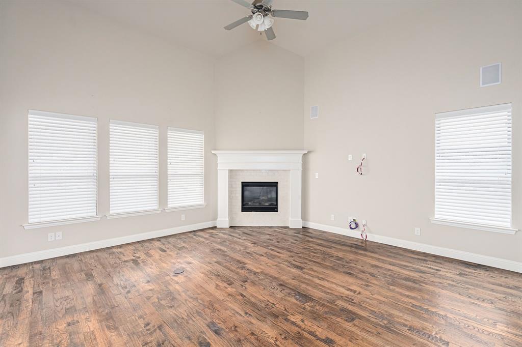 1506 Mariners Hope Way Wylie, TX 75098 - Photo 10 of 28 a view of an empty room with a window and a fireplace