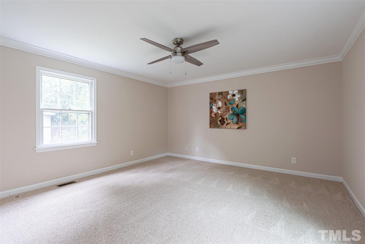 1701 Pony Run Road Raleigh, NC 27615 - Photo 11 of 30 First Floor Master Bedroom with crown molding, HUGE walk-in closet w/ shoe station- ceiling fan.