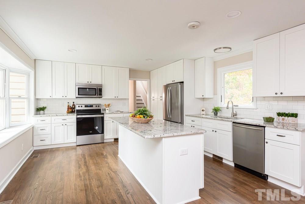1701 Pony Run Road Raleigh, NC 27615 - Photo 7 of 30 Gourmet Kitchen featuring stainless steel appliances and huge island with overhang for bar stools.