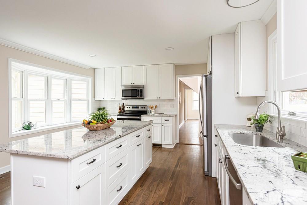 1701 Pony Run Road Raleigh, NC 27615 - Photo 8 of 30 Brand new kitchen with Lots of cabinet space for storage, tile backsplash, and granite countertops.