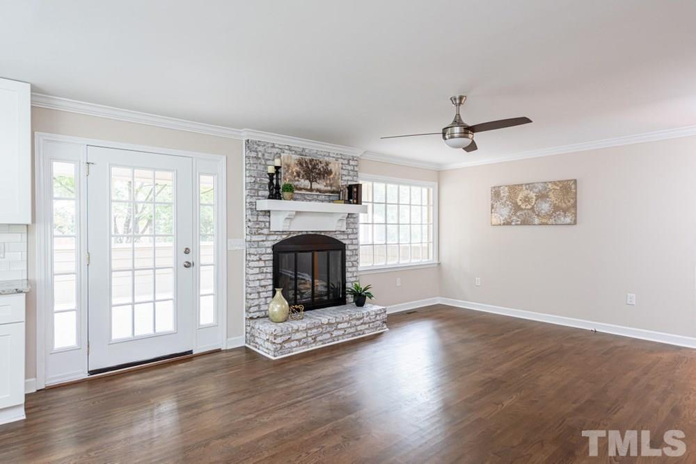 1701 Pony Run Road Raleigh, NC 27615 - Photo 10 of 30 Family Room/Breakfast Nook area with ceiling fan, gas log fireplace, and crown molding. Gorgeous hardwood floors