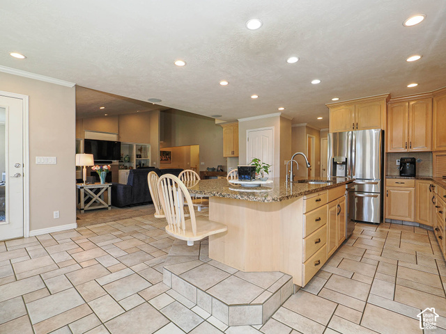 11779 South Stone Ridge Court Ridge West Riverton, UT 84065 - Photo 25 of 85 Kitchen featuring light wood cabinetry, recessed lighting, stainless steel refrigerator, and a granite-finish island with integrated seating