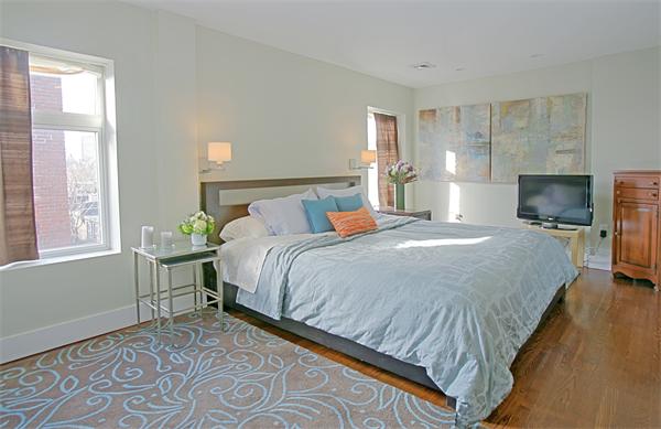 15 Warren Avenue, Unit 7 Boston, MA 02116 - Photo 5 of 9 a bedroom with a bed and wooden floor