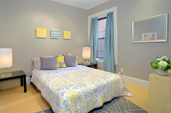 15 Warren Avenue, Unit 7 Boston, MA 02116 - Photo 6 of 9 a large bed sitting in a bedroom next to a window