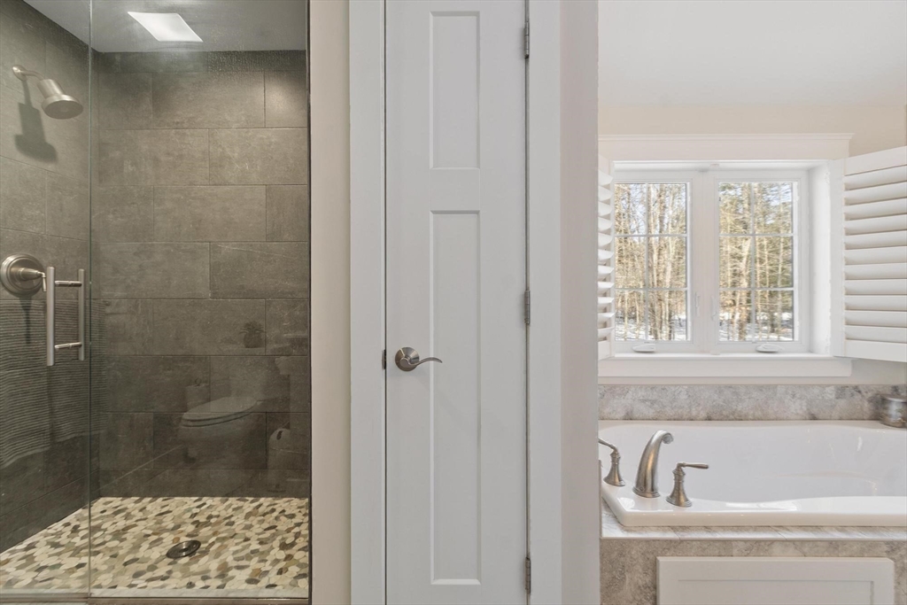 3 Swett Drive Hampton, NH 03842 - Photo 14 of 42 a bathroom with a bathtub and a shower