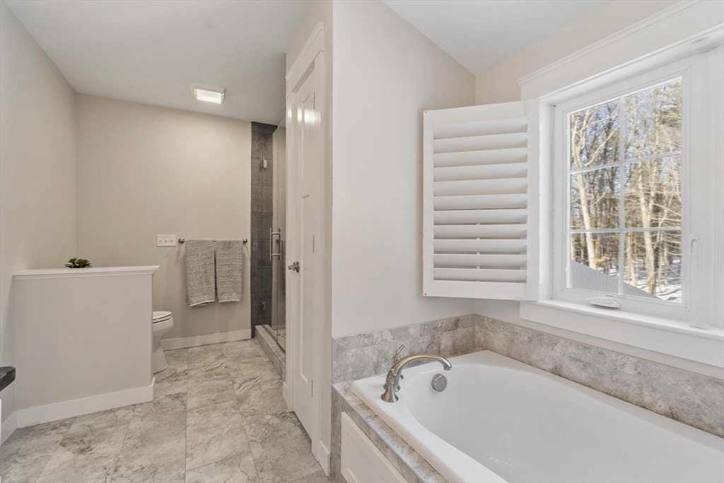 3 Swett Drive Hampton, NH 03842 - Photo 18 of 42 a bathroom with a bathtub and a window