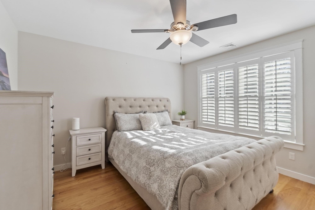 3 Swett Drive Hampton, NH 03842 - Photo 22 of 42 a bedroom with a large bed and a chandelier