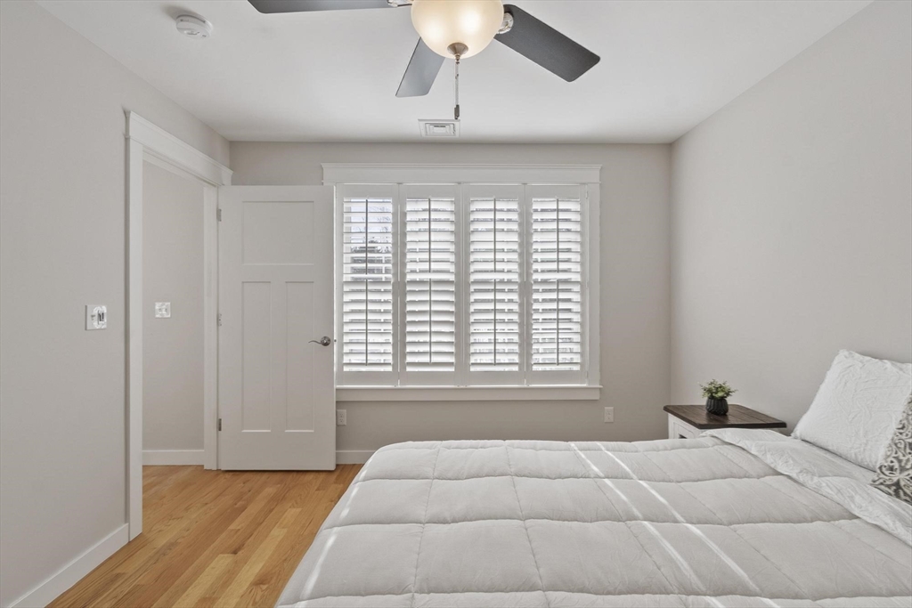 3 Swett Drive Hampton, NH 03842 - Photo 23 of 42 a bedroom with a bed and a chandelier