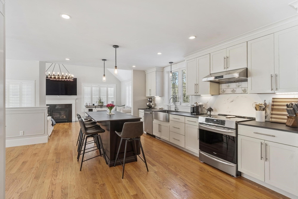 3 Swett Drive Hampton, NH 03842 - Photo 5 of 42 a kitchen with stainless steel appliances a dining table and chairs
