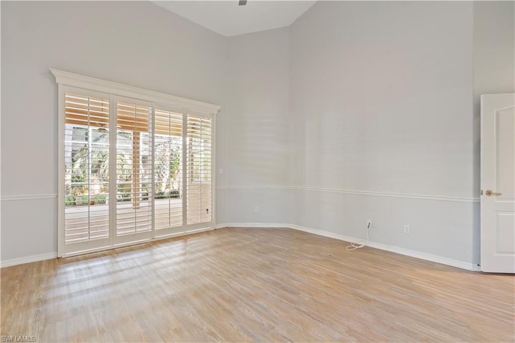 20751 Rivers Ford Estero, FL 33928 - Photo 25 of 36 Empty room with a high ceiling and light wood-style flooring