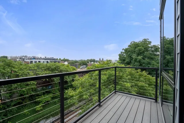a view of balcony with wooden floor and fence