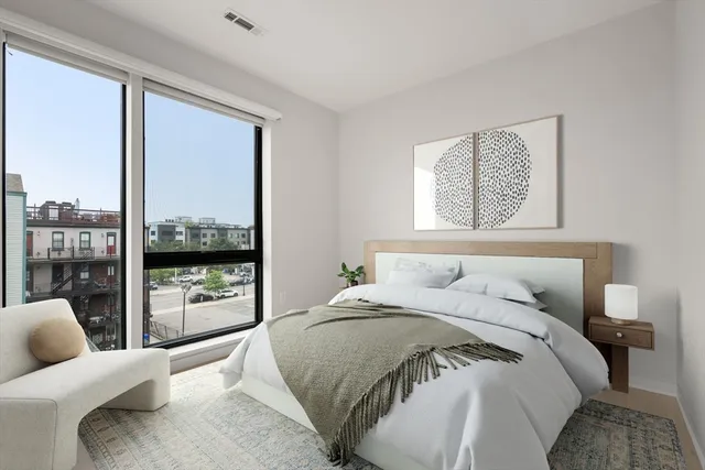 a bedroom with a large bed and a large window