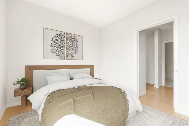 a bedroom with a bed and a painting on the wall