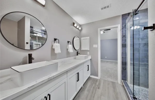 a spacious bathroom with a double vanity sink and a mirror